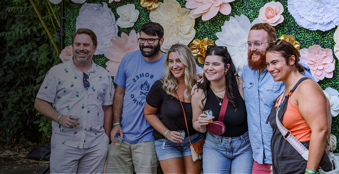 People smiling holding drinks